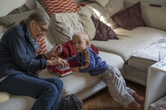 Great-grandmother playing with her great-grandson, two years old, Othenstorf, Mecklenburg-Western