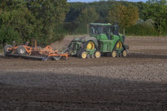 Crawler tractors harrow the field, Othenstorf, Mecklenburg-Western Pomerania, Germany
