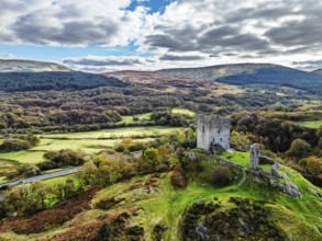 Autumn colours over Castell Dolwyddelan and Eryri Mountains from a drone, Snowdonia, Conwy County
