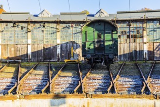 Historic railroad car parked in front of the old engine shed, Augsburg railway park, administrative
