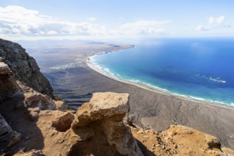 View from the Risco de Famara Cliff to Famara Beach, Playa de Famara with La Calaeta, Lanzarote,
