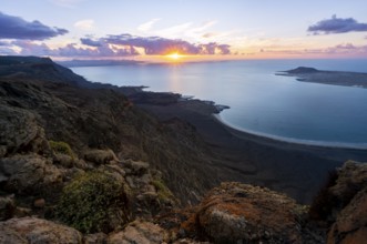 View from steep cliffs to sea and coast with sun stars, Mirador del Porrito viewpoint at sunset,