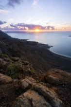 View from steep cliffs to sea and coast with sun stars, Mirador del Porrito viewpoint at sunset,