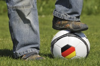 A boy's foot on a football, Germany