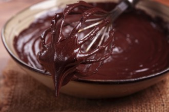 A bowl of chocolate dough, a whisk for whipping, baking, structure and consistency, homemade, top