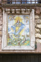Historic ceramic tiles religious image above doorway, medieval village of AlbarracÃ­n, Teruel