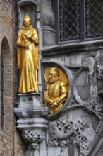 Golden figures on the faÃ§ade of the St. Ivo Chapel at the Basilica of the Holy Blood, Castle