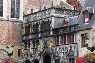 Richly decorated faÃ§ade and entrance portal with golden figures to the St. Ivo Chapel at the