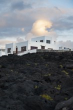 Typical white houses in the town of La Santa, at sunset, black volcanic rocks, Lanzarote, Canary