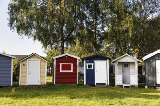 Different colored beach huts in a meadow, Ystad, Sweden