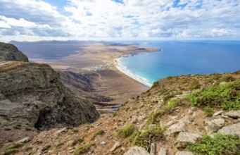 View from the Risco de Famara cliffs to the coast and the sea with the Famara beach, Playa de