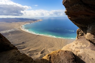 Cueva de las Cabras cave, view from the Risco de Famara cliffs on Famara beach, Playa de Famara