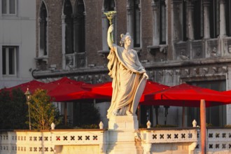 Woman wearing a skewer on the terrace of the Hotel farmer, Palazzo am Canal Grande Venice Italy