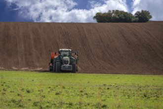 Farmer cultivates his field with a large tractor, Mecklenburg-Vorpommern, Germany