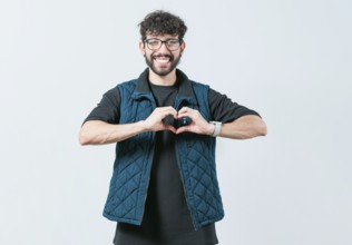 Funny man making heart shape isolated. Handsome guy making heart shape with hands