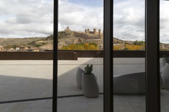View of castle through glass windows of new Parador de Molina de AragÃ³n, Guadalajara province,