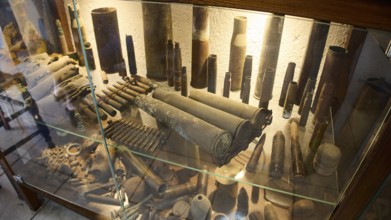 Display case with numerous antique cartridge cases and military equipment, War Museum, Military