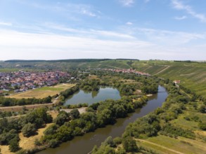 Wide river meandering through a green landscape with a village on the banks, Nordheim am Main,