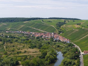 Small village surrounded by green hills and farmland, flanked by a river, Escherndorf near Volkach,