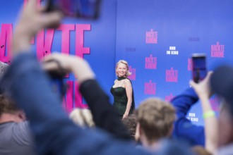 Pamela Anderson between fans at the film premiere of The Naked Gun at UCI Luxe East Side Gallery,