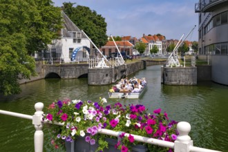 Middelburg, Zeeland, Netherlands - Town houses on the inner harbour in the old town. Tourists take