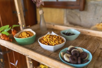 Colorful candy and snacks served on a wooden tray during a wedding celebration, adding a touch of
