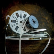 Old film strip reel showcasing vintage cinema history and its storytelling essence in a rustic