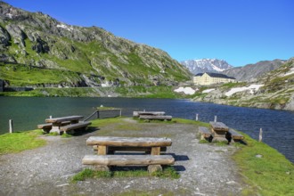 View of small island with wooden benches in mountain lake Alpine lake Lac du Grand Gd Saint St