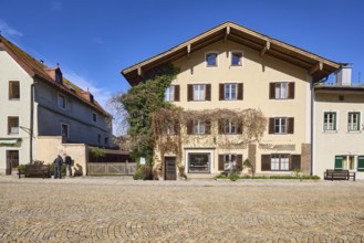 Historic houses, facade, window, door, shutters, square, cobblestones, blue sky, cirrostratus