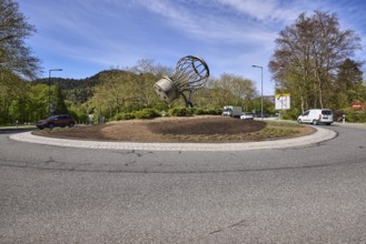 Saltworks roundabout, lantern, trees, vehicles, stainless steel sculpture salt shaker, blue sky,
