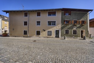 Historical buildings, houses, facade, windows, doors, alleyway, cobblestones, bollards, blue sky,