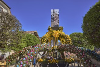 Easter fountain, Easter decoration, blown out coloured Easter eggs, trees, historical buildings,