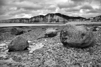 Steep coast, cliffs, coastal landscape, rocks on the beach, pebbles, black and white, behind Yport,