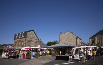 Weekly market with regional products, behind it co-operative bank, savings bank Crédit Agricole,