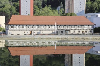 Armoury museum built in 1668 with modern skyscrapers and reflection, half-timbered house, pond,