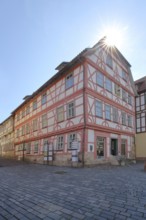 Red half-timbered house against the light, Lutherhaus, Lutherplatz, Schmalkalden, Franconia,