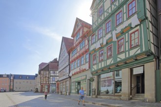 Red, green and brown half-timbered houses against the light, pedestrians, colourful, idyll, Auer