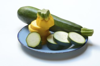 Green and yellow courgettes on a plate, Cucurbita pepo