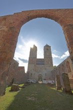 Romanesque St. Mary's Collegiate Church backlit with archway, twin towers, church ruins, interior