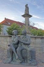 Market fountain with bronze sculpture, modern art, male figure, female figure, couple, sitting,
