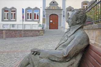 Johann Wolfgang von Goethe by Klaus Gutting sitting on the bench, arms, bronze sculpture, looking,