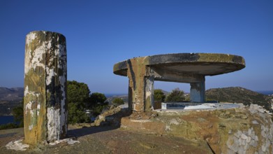 Concrete bunker with round platform high on a hill under a clear sky, Lost Place, Lago