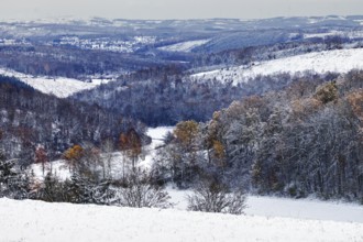 Snow-covered hills with forests, a wintery and quiet landscape stretches far and wide, Siegen