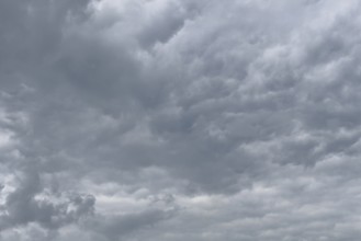A gathering rain front of grey clouds forms a closed cloud cover, international