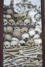 Shrine with human skull, memorial to the victims of the Khmer Rouge regime, Wat Thmei, Siem Reap,