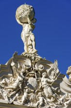 Façade with angel figures, putti around the Bavarian coat of arms, statue of Atlas with the vault