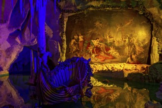 Colourful illumination of King Ludwig II's Venus Grotto, artificial stalactite cave, lake with