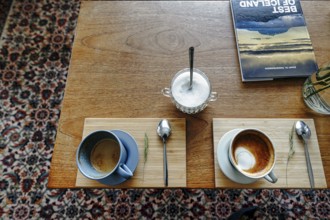 Two cups of coffee, cappuccino, coffee speciality, table decoration in a café, view from above,