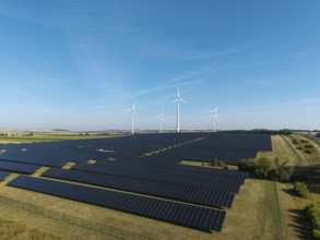 Renewable energy sources with solar and wind systems on an extensive field, near Kitzingen, Lower