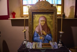 Icon of Panagia Kyra, Religious icon with candles and decorations in a warmly lit interior, Pandeli